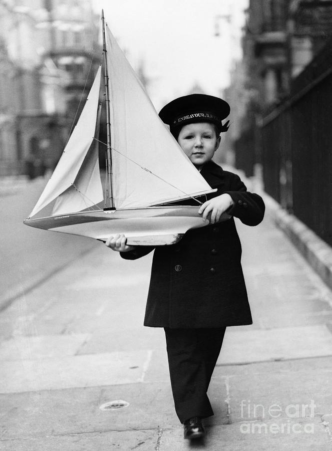 Boy With Toy Sailboat Photograph by Bettmann