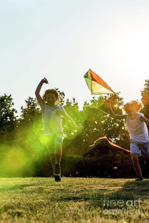 Boys Holding Kite In Park by Science Photo Library