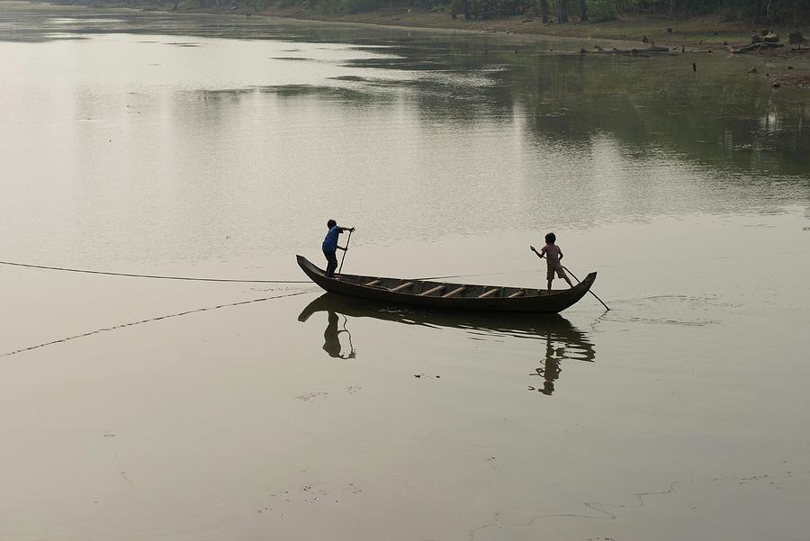 Boys Paddling Their Boat In The East Photograph by Dave Stamboulis ...