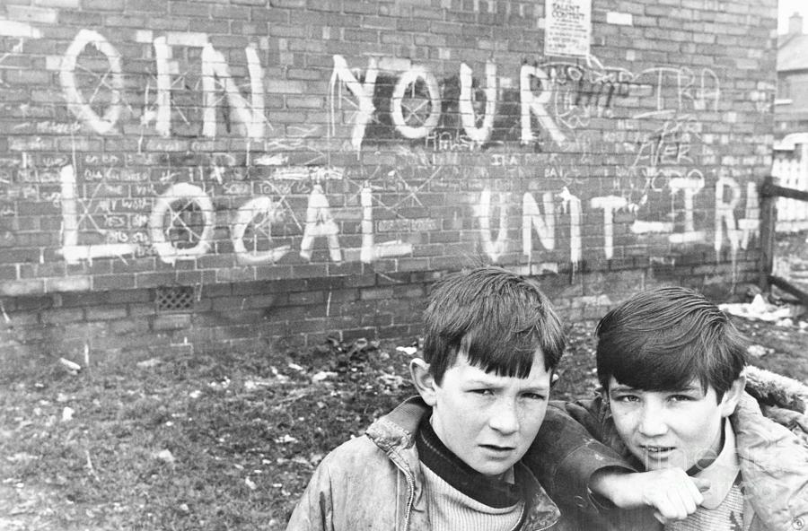 Belfast Photograph - Boys Play Near Graffitied Wall by Bettmann