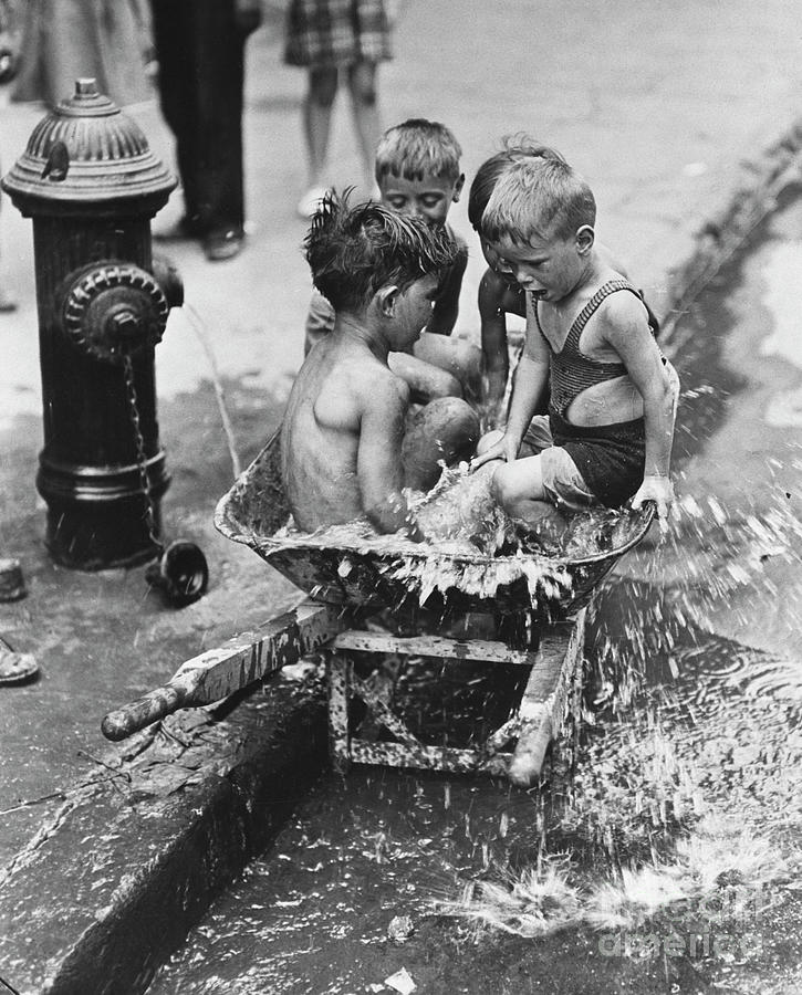 Boys Splashing By A Fire Hydrant Photograph by Bettmann