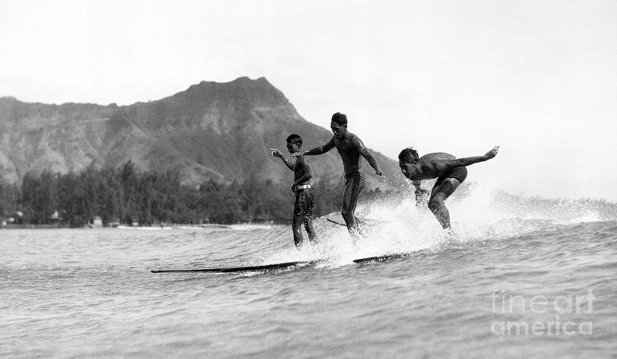 Boys Surfing Mountains In Background Photograph by Bettmann
