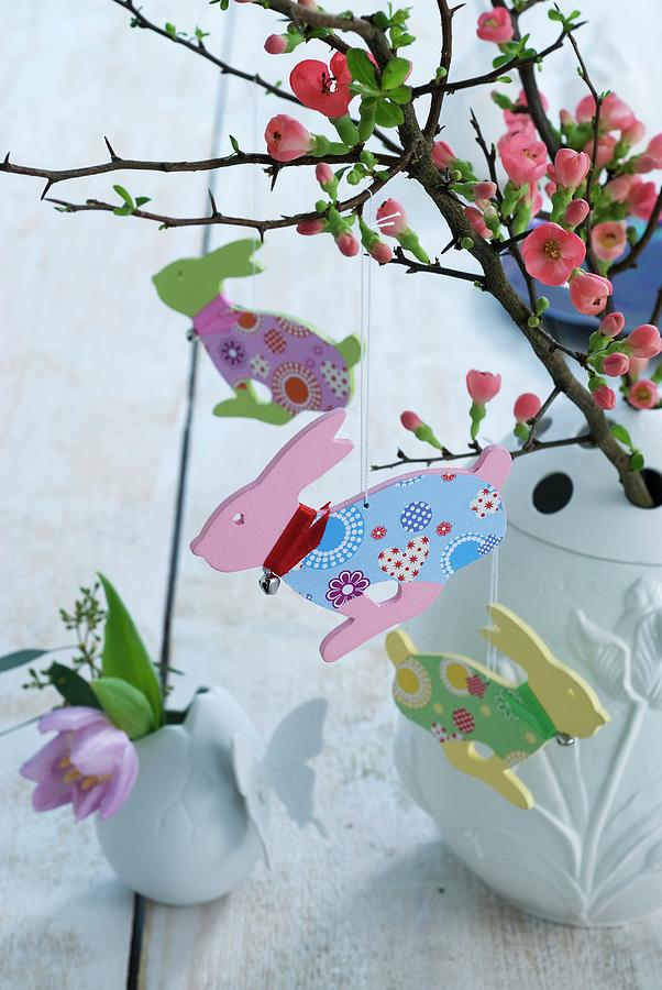 Branch Of Flowering Quince Decorated With Wooden Easter Bunnies Photograph by Matteo Manduzio