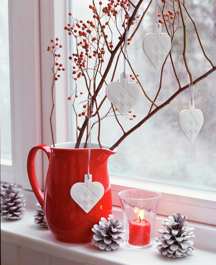 Branches Of Miniature Rose Hips And China Love-hearts In Red Jug On Windowsill Photograph by Veronika Stark