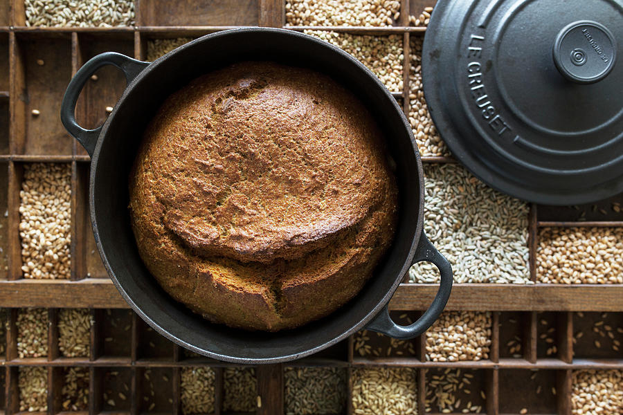 Bread, Baked In A Cast-iron Pot, On A Set Of Different Grains Photograph by Nicole Godt