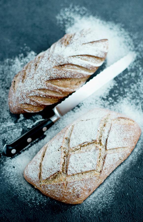 Bread Dusted With Flour With A Bread Knife Photograph by Jamie Watson