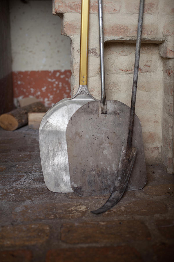 Bread Shovels In Front Of An Oven Photograph by Eising Studio