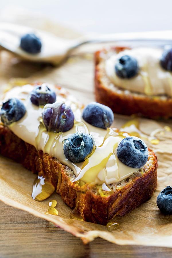 Bread Topped With Cashew Nut Butter, Blueberries And Honey Photograph by Sandra Krimshandl-tauscher