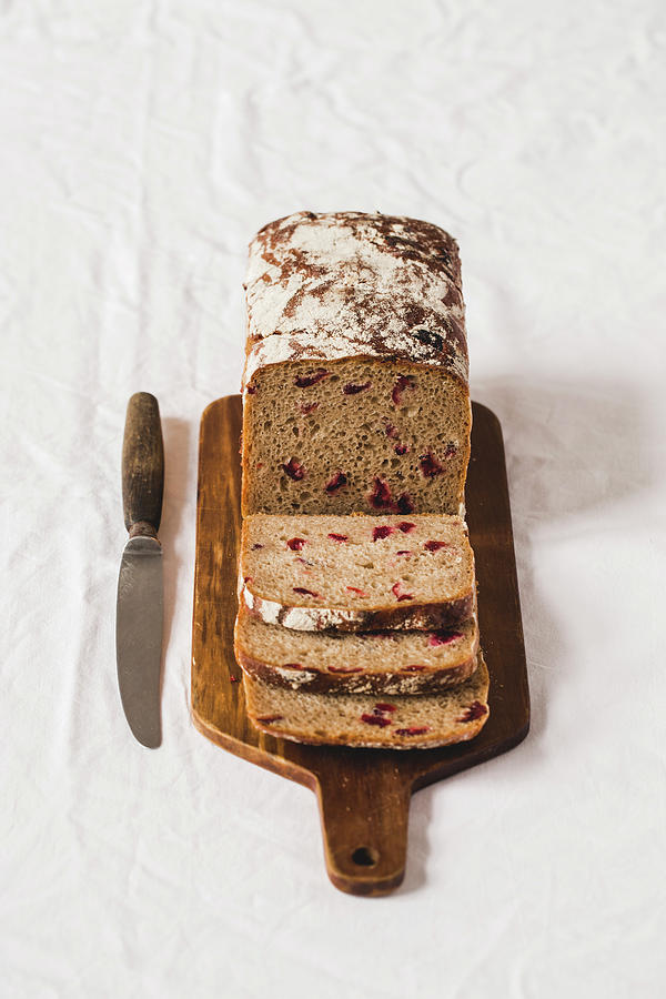Bread With Dried Berries, Sliced On A Wooden Board Photograph by Karolina Kosowicz