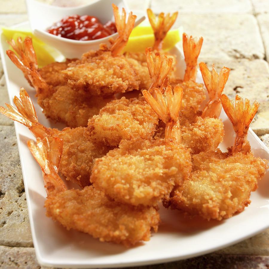 Breaded Fried Prawns With Lemon Slices And A Seafood Sauce Photograph ...