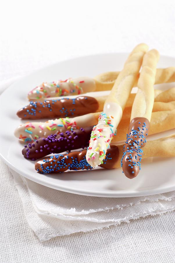 Breadsticks With Chocolate Glaze And Sugar Sprinkles Photograph by Franco Pizzochero