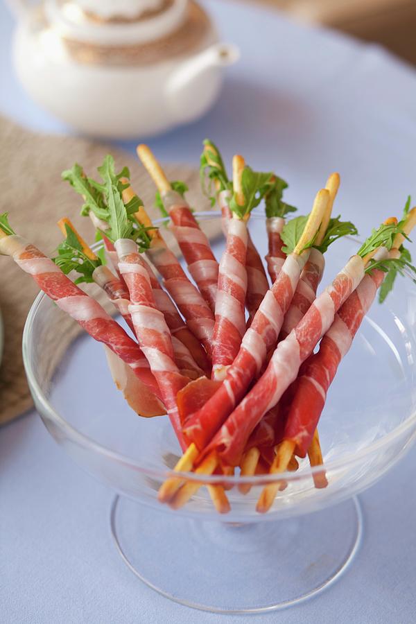 Breadsticks With Rocket And Parma Ham Photograph by Studio Lipov