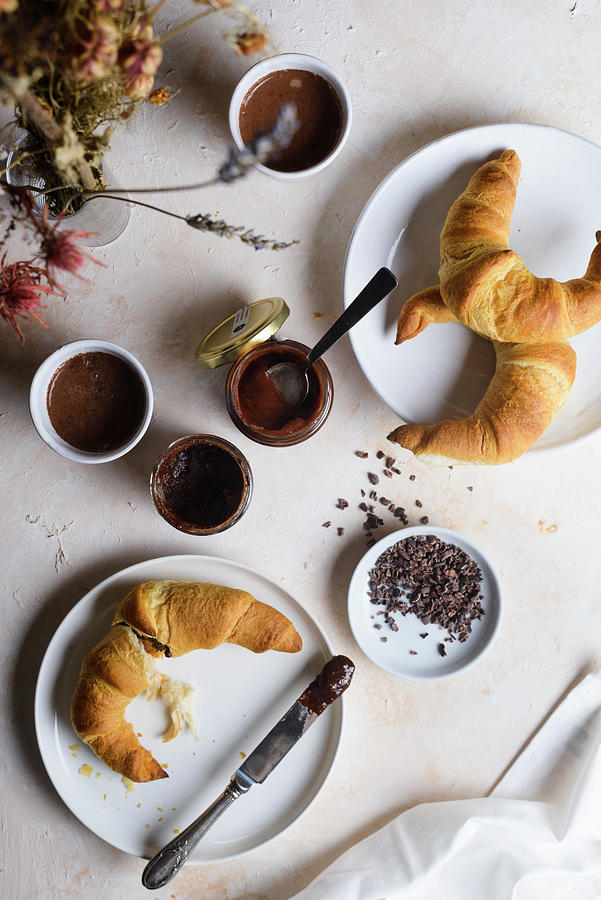 Breakfast With Croissants, Cocoa, Hazelnut Spread And Cocoa Nibs Photograph by Leah Bethmann