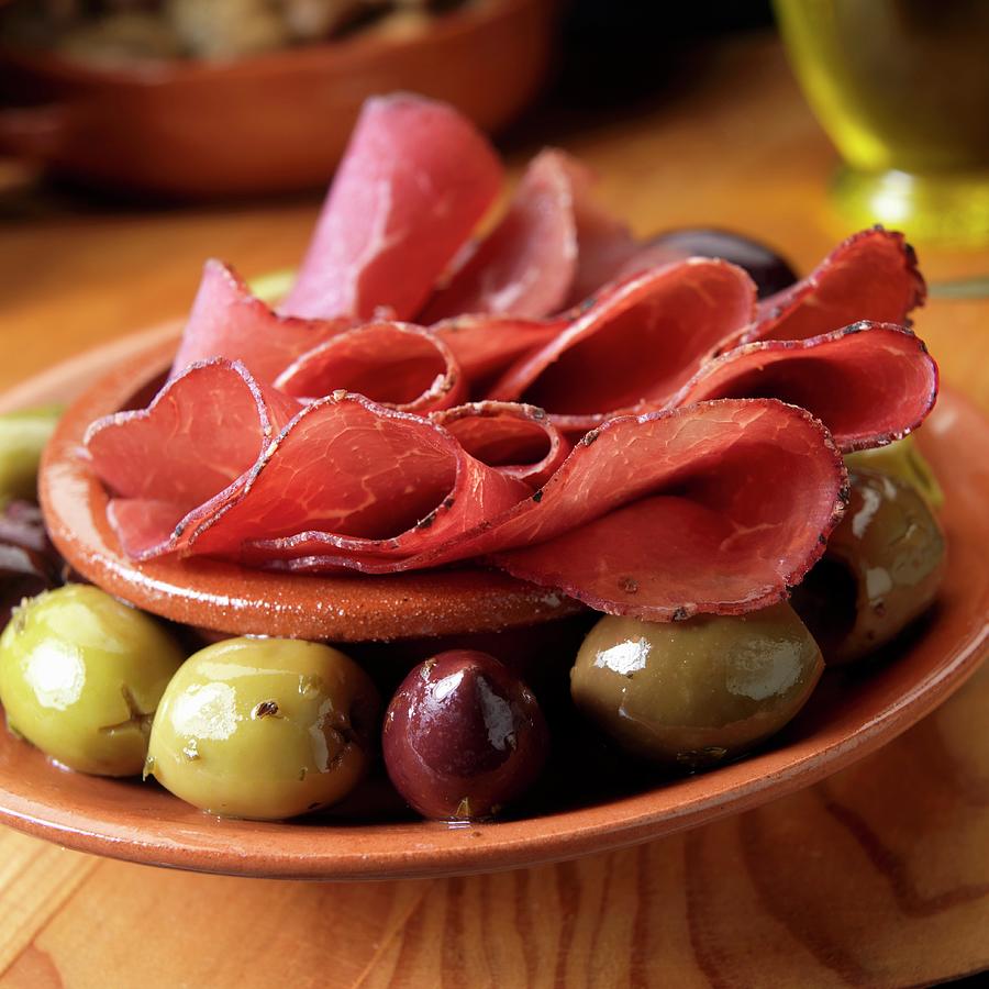Bresaola, Italian Air Dried Beef With Olives As Appetizer Photograph by Paul Poplis