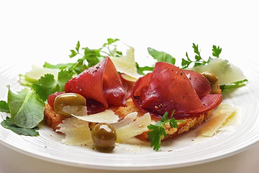 Bresaola On Bruschetta With Parmesan, Olives And Sald Photograph by Robert Morris