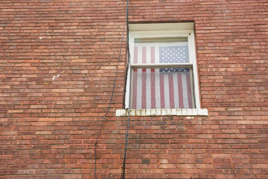 Brick Wall and Window with Flag Photograph by Tom Cochran
