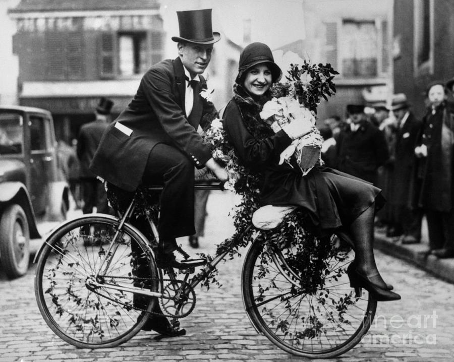 Bride And Groom Riding Bicycle Photograph by Bettmann