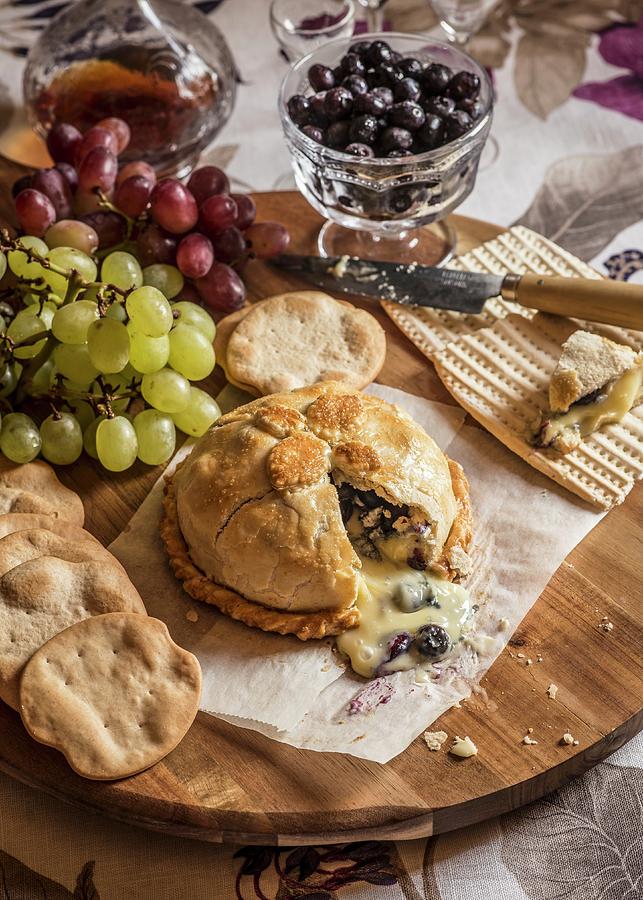 Brie En Croute Served With Grapes And Crackers Photograph by Miriam Garcia