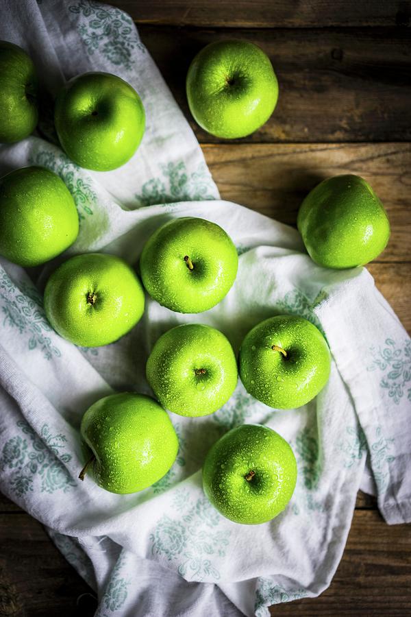 Bright Green Apples On Wooden Surface Photograph by Alena Haurylik