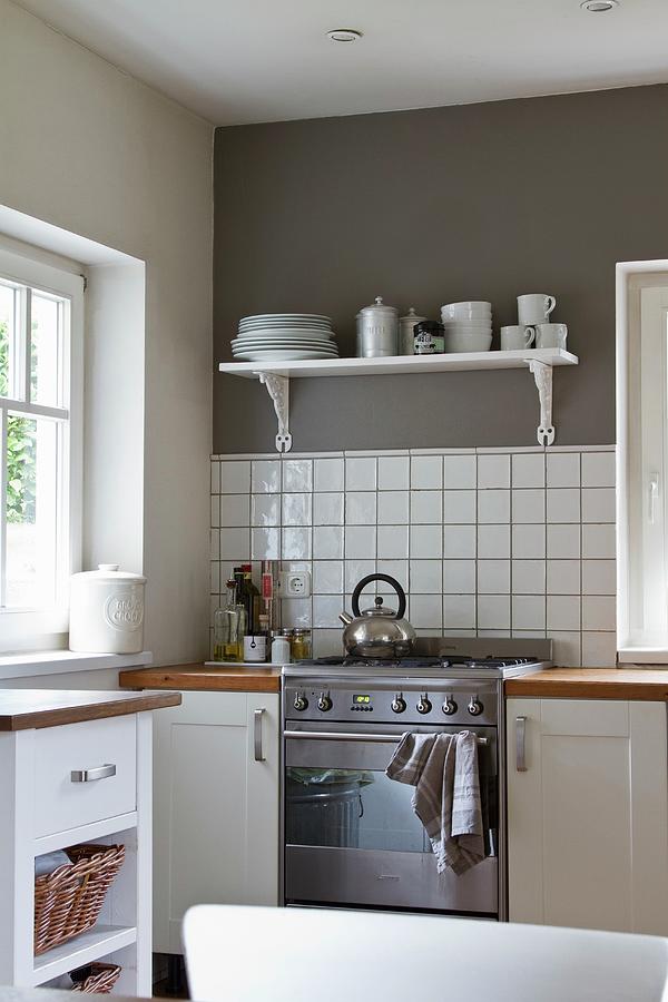 Bright, Pleasant Kitchen With Mushroom-grey Wall Above White Tiled Splashback Photograph by Catja Vedder