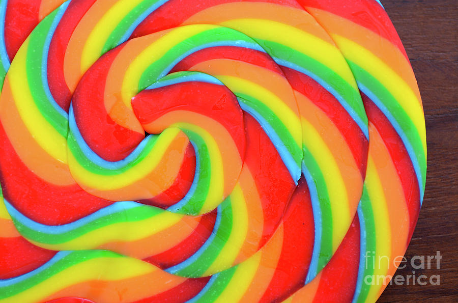Bright rainbow lollipop candy Photograph by Milleflore Images