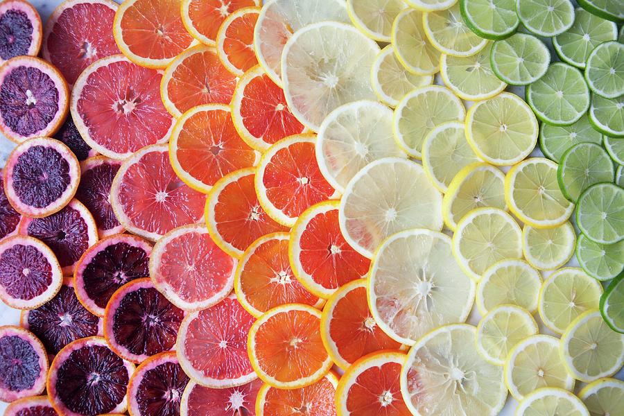 Brightly Coloured Citrus Fruit Slices In Rows Photograph by Debra Cowie