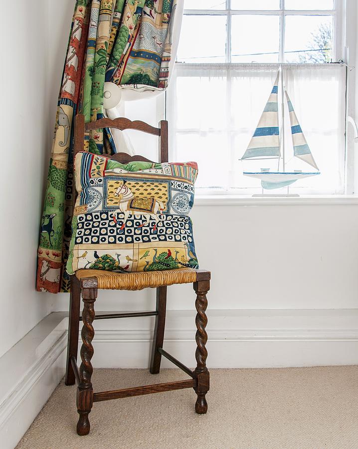 Brightly Patterned Curtain And Cushion Next To Window Photograph by Stuart Cox