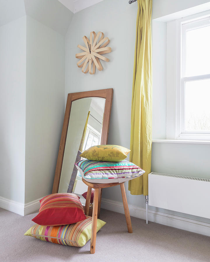 Brightly Striped Cushions On And Next To Stool In Front Of Mirror Photograph by Stuart Cox