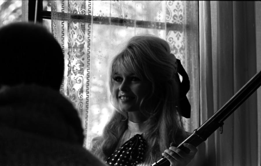 Brigitte Bardot Laughing Holding Gun Photograph By Don Ornitz