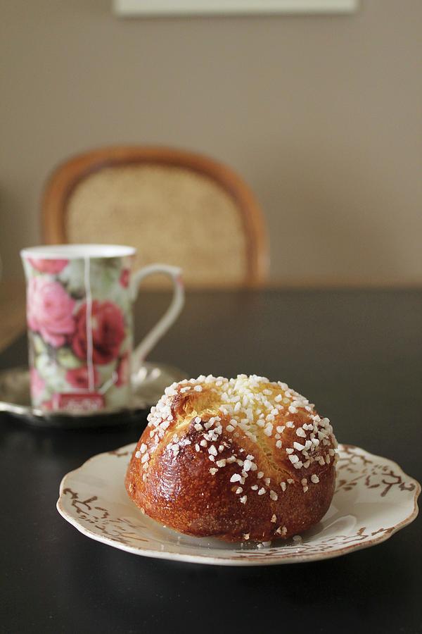 Brioche With Sugar Nibs And Tea In A Floral-patterned Mug Photograph by Patricia Miceli
