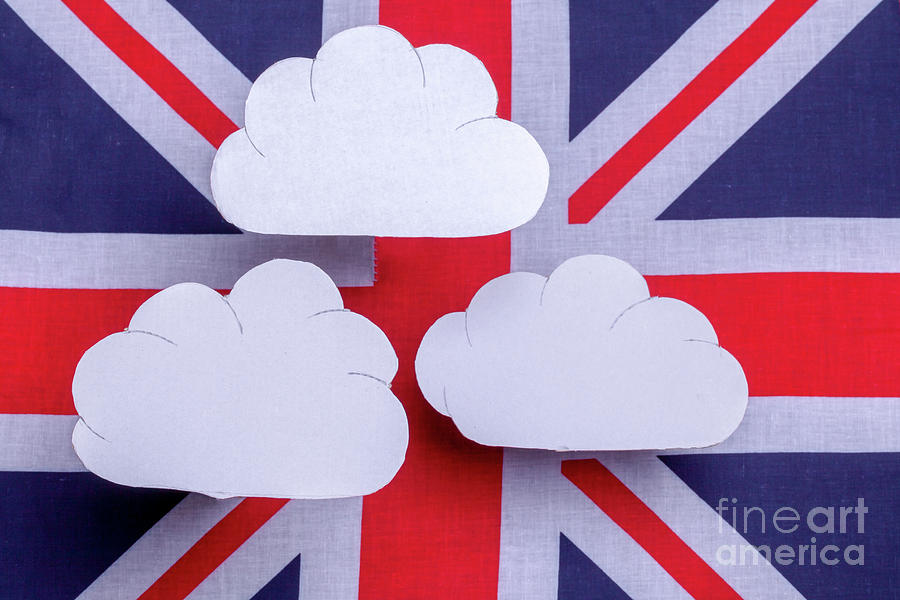 British flag with three white clouds floating above Photograph by Simon Bratt