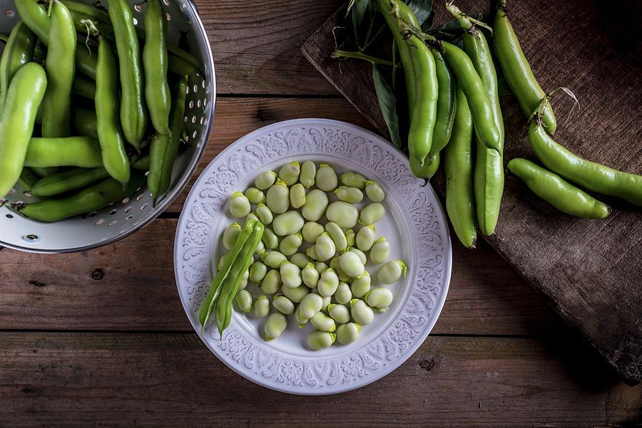 Broad Beans Pods And Shelled Broad Beans On A White Plate Photograph by Nitin Kapoor
