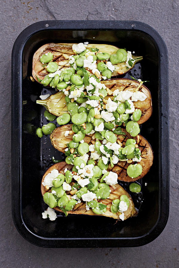 Broad Beans Sprinkled Over Aubergines With Cheese In A Roasting Dish Photograph by Steven Joyce