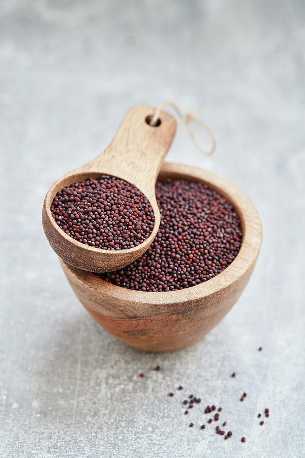 Broccoli Seeds In A Wooden Bowl And A Wooden Scoop Photograph by Brigitte Sporrer