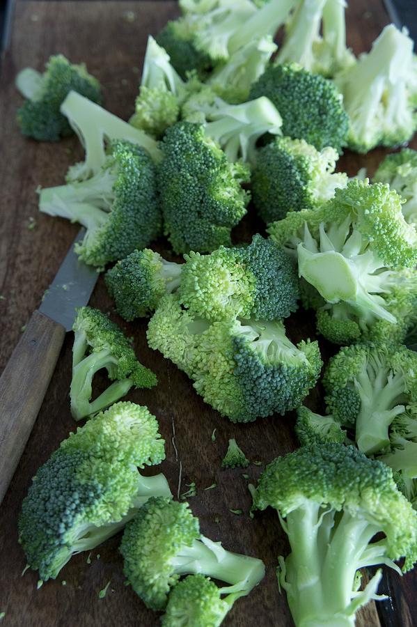 Broccoli With A Knife On A Chopping Board Photograph by Martina Schindler