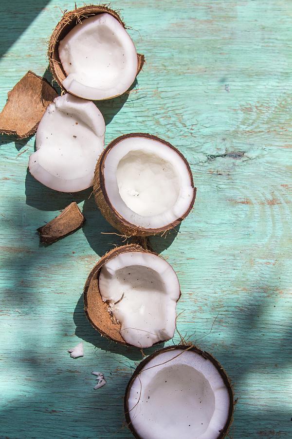 Broken Coconuts On A Wooden Board In Sunlight Photograph by Maru ...
