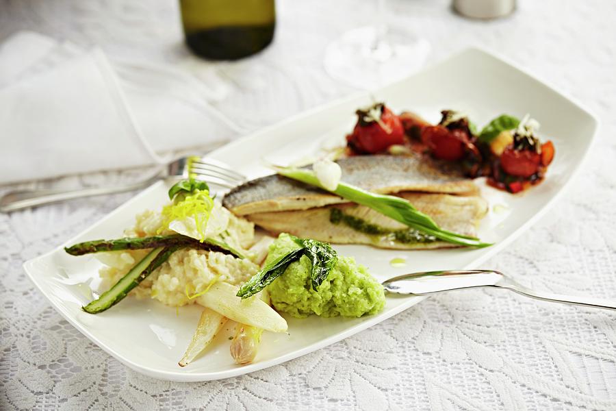 Brook Trout With Asparagus Risotto, Wild Garlic Pure And Braised Tomatoes Photograph by Herbert Lehmann