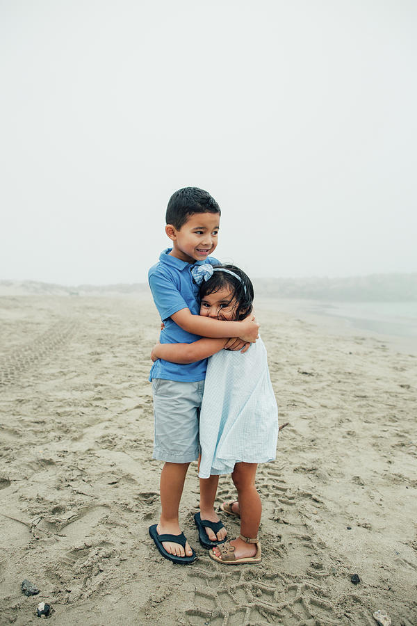 Beach Photograph - Brother And Sister Hug On The Foggy Beach by Cavan Images
