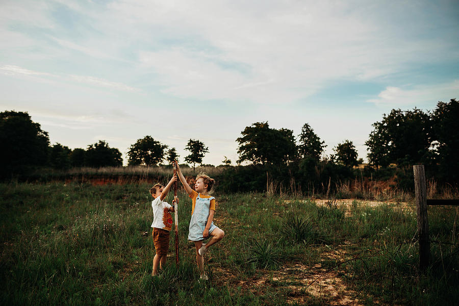 Brother And Sister Standing In Open Field At Sunset Photograph by Cavan ...