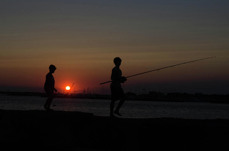 Brothers fishing at sunset Photograph by Alan Goldberg