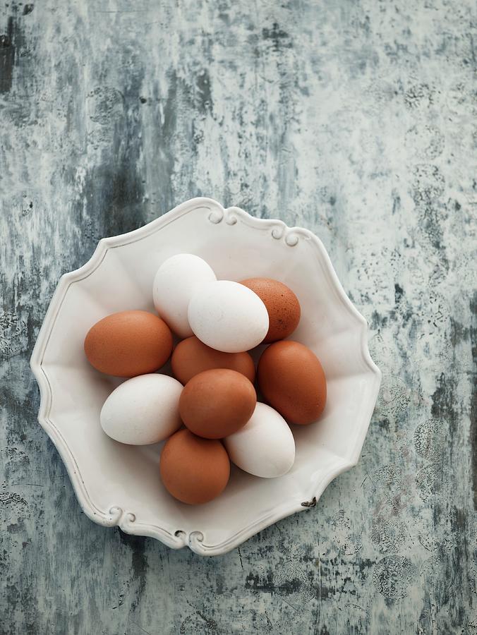 Brown And White Eggs On A Ceramic Plate Photograph by Mikkel Adsbl