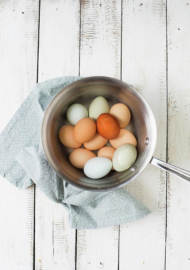 Brown Eggs In A Pot Of Water Photograph by Sabine Steffens