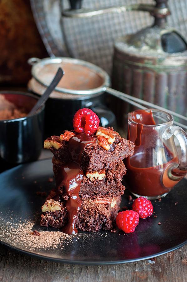 Brownies With Pecan Nuts, Chocolate Sauce And Raspberries Photograph by Irina Meliukh