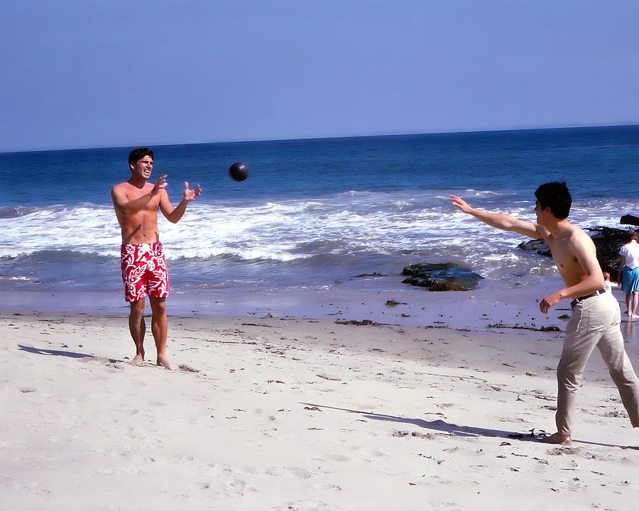 Bruce Lee Photograph - Bruce Lee And Van Williams Playing Ball On The Beach by Globe Photos