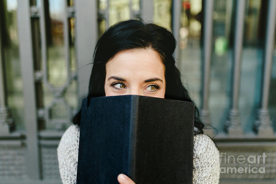 Brunette And Shy Young Woman Making Future Plans And Pointing Them In Her Notebook, Hiding Herself With A Mischievous Face. Photograph by Joaquin Corbalan