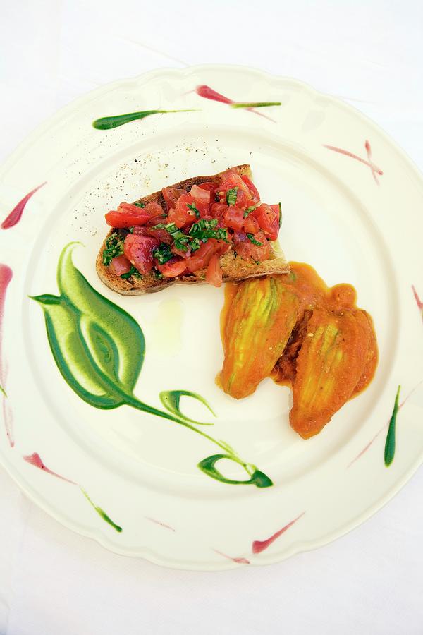 Bruschetta E Fiori Di Zucca grilled Bread Topped With Tomatoes Served With Stuffed Courgette Flowers, Italy Photograph by Michael Wissing