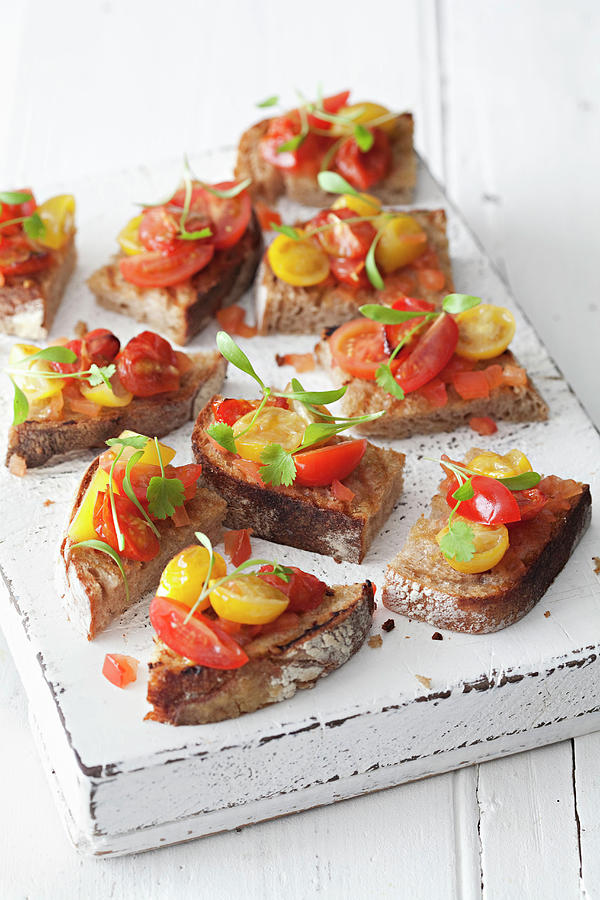 Bruschetta Laid Out On A White Wooden Board Photograph by Steven Joyce