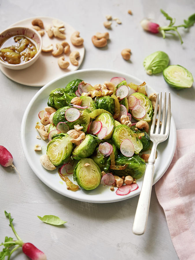 Brussels Sprout,radish And Cashew Salad With Turmeric Vinaigrette Photograph by Zo & Blaise
