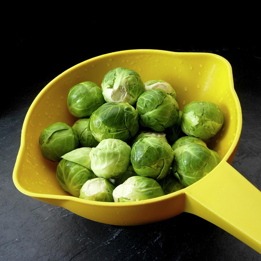 Brussels Sprouts In Yellow Colander Photograph by Paul Poplis