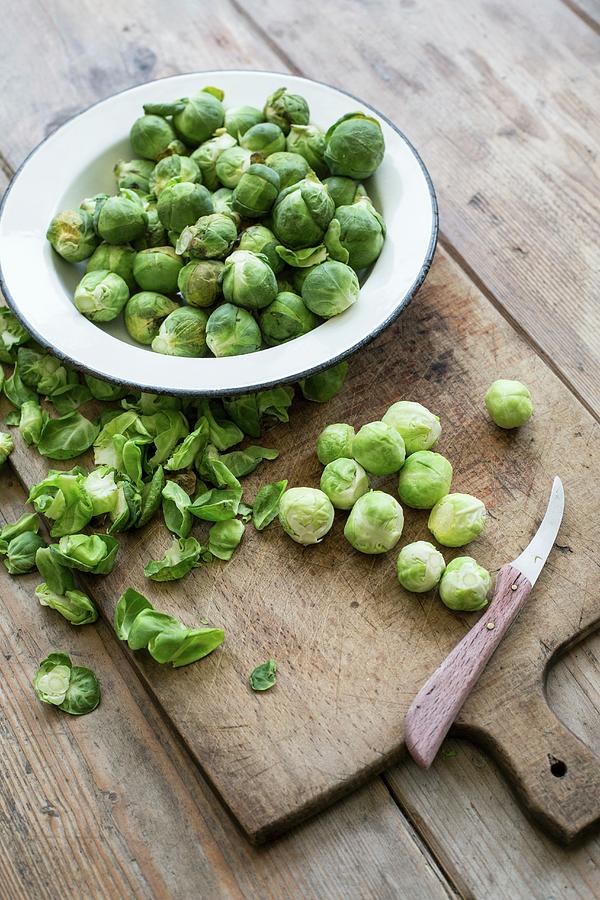 Brussels Sprouts On A Chopping Board Photograph by Sabine Steffens
